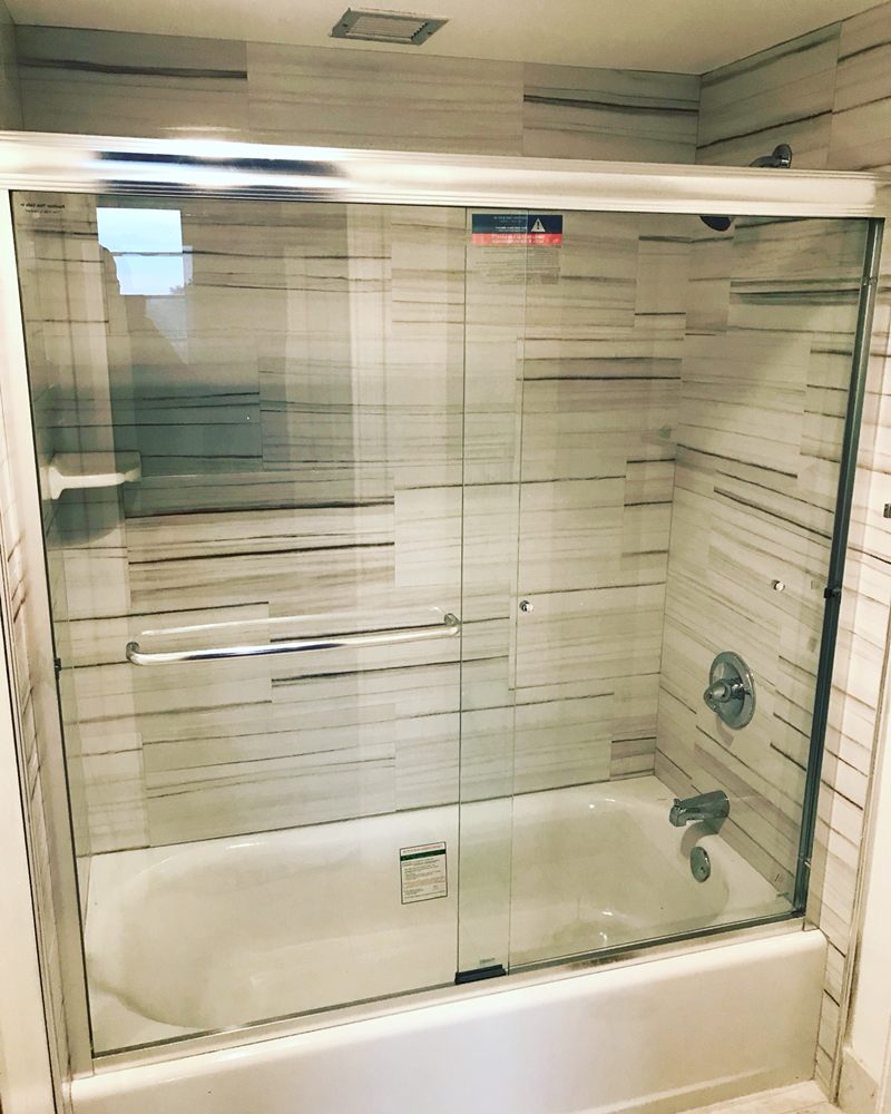 Tub to shower conversion with frameless glass enclosure - bathroom renovation Fort Lauderdale