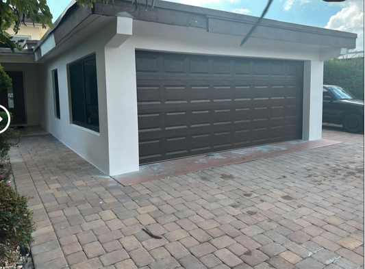 Carport to garage conversion completed - modern garage addition with paver driveway Naples FL