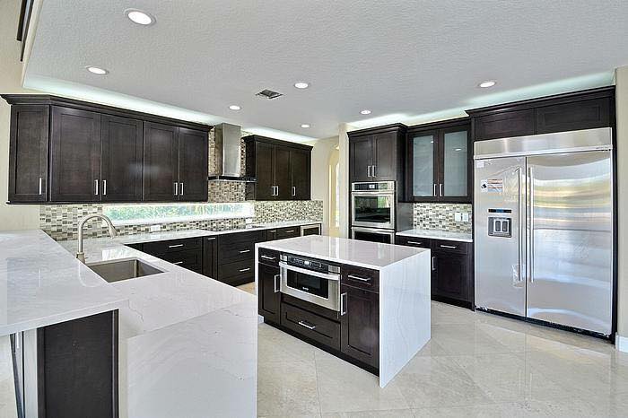 Open concept luxury kitchen with island and pool view in Southwest Florida